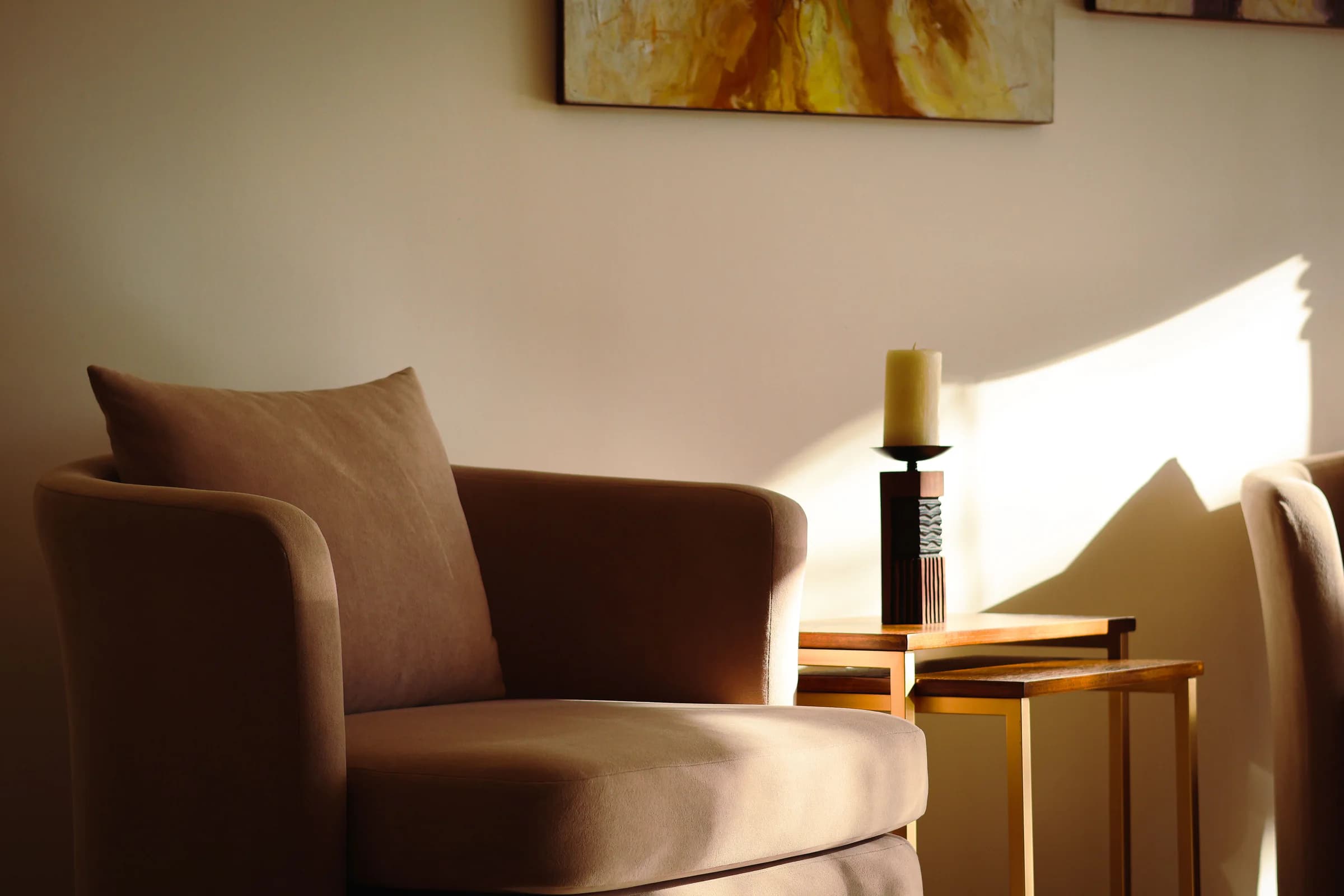 A warm counselling room with comfortable chairs and soft afternoon light